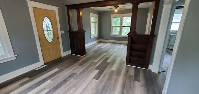 217 Flynn St, Redwood Falls, MN 56283 - entryway featuring decorative columns, dark wood finished floors, baseboards, a ceiling fan, and ornamental molding