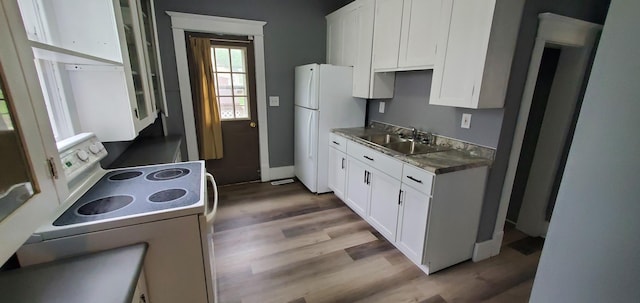 217 Flynn St, Redwood Falls, MN 56283 - kitchen with white appliances, a sink, white cabinetry, and light wood-style floors