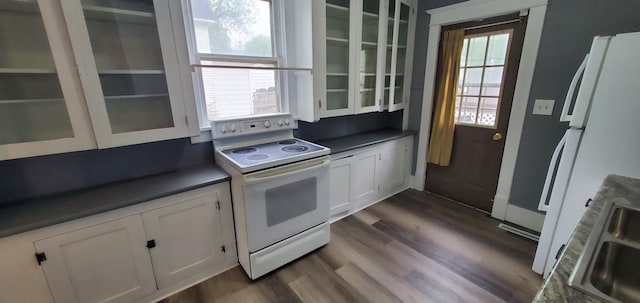 217 Flynn St, Redwood Falls, MN 56283 - kitchen with white appliances, dark countertops, glass insert cabinets, and white cabinetry