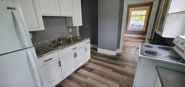 217 Flynn St, Redwood Falls, MN 56283 - kitchen with white appliances, a sink, dark wood finished floors, white cabinets, and baseboards
