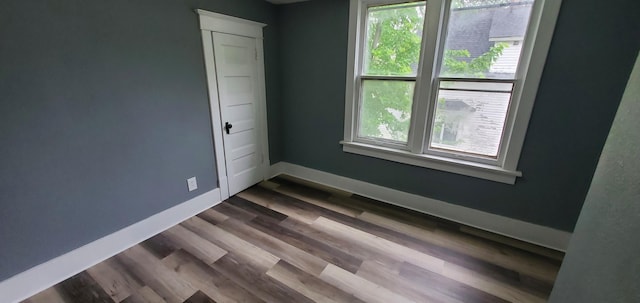 217 Flynn St, Redwood Falls, MN 56283 - unfurnished room featuring healthy amount of natural light, baseboards, and dark wood finished floors