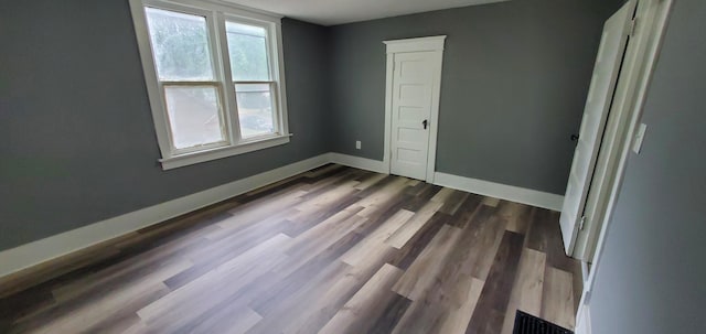 217 Flynn St, Redwood Falls, MN 56283 - unfurnished bedroom featuring baseboards and dark wood-type flooring