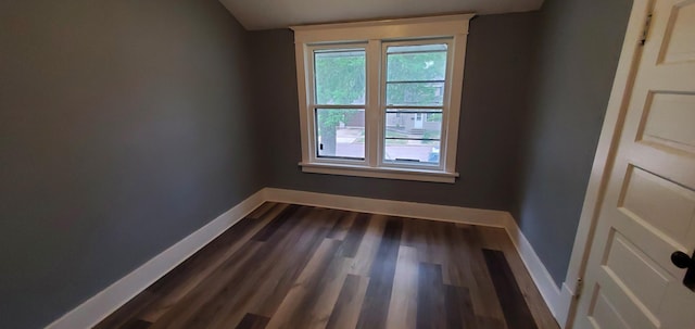 217 Flynn St, Redwood Falls, MN 56283 - empty room with baseboards, dark wood-type flooring, and vaulted ceiling