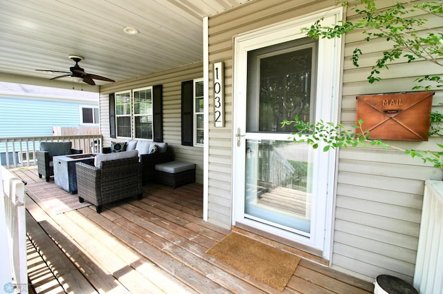 deck featuring ceiling fan, covered porch, and outdoor lounge area