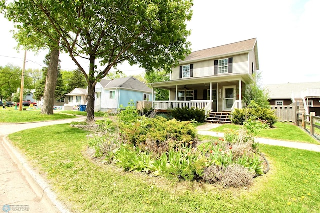 view of front of property featuring covered porch and a front yard