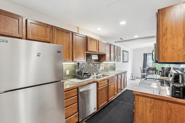21113 Clydesdale Curv, Forest Lake, MN 55025 - kitchen featuring stainless steel appliances, a sink, brown cabinets, decorative backsplash, and recessed lighting