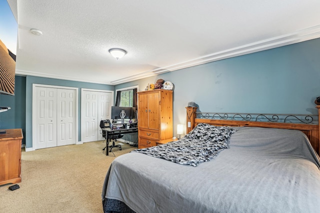 21113 Clydesdale Curv, Forest Lake, MN 55025 - carpeted bedroom with multiple closets, a textured ceiling, a desk, and baseboards