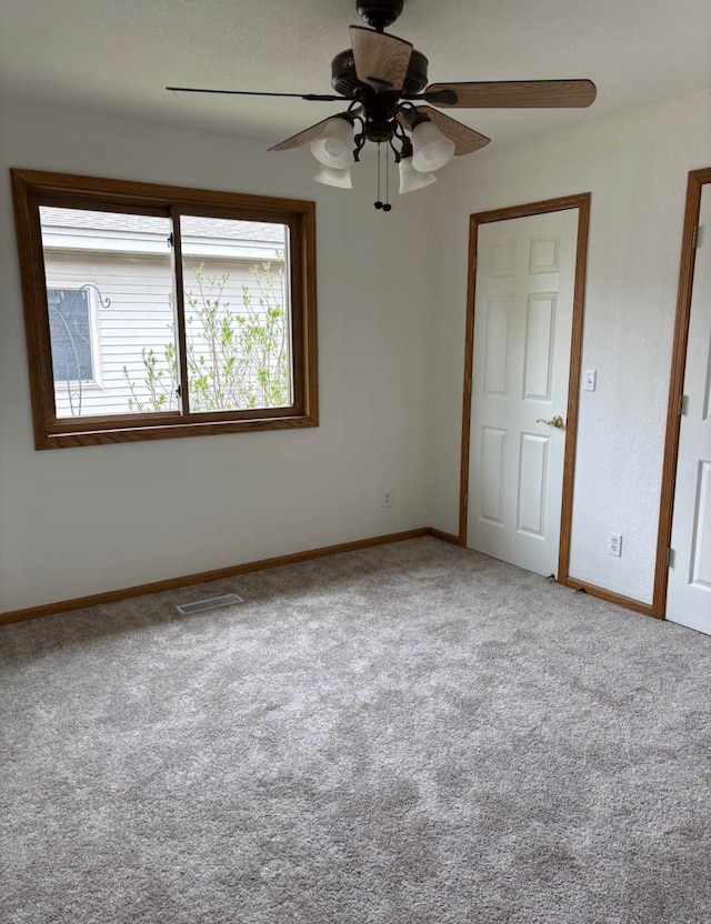 1432 Tall Grass, Hudson, WI 54016 - unfurnished bedroom with multiple windows, carpet, baseboards, and a ceiling fan