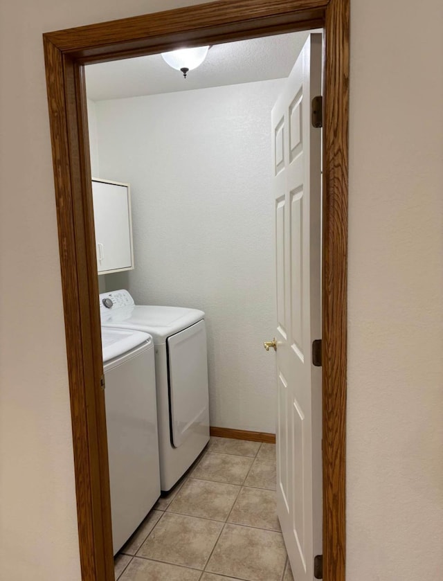 1432 Tall Grass, Hudson, WI 54016 - washroom featuring washing machine and clothes dryer, cabinet space, light tile patterned floors, and baseboards