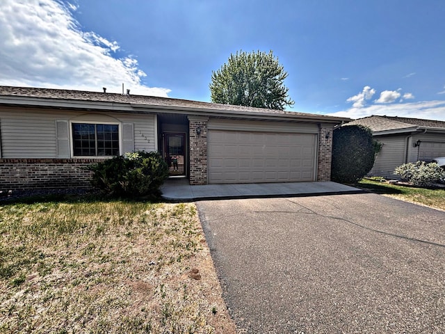 1432 Tall Grass, Hudson, WI 54016 - ranch-style house with asphalt driveway, brick siding, and a garage