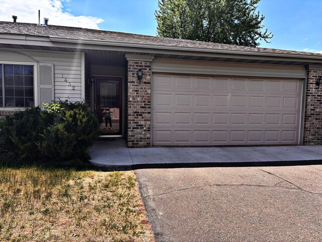 1432 Tall Grass, Hudson, WI 54016 - view of front of house with brick siding, a garage, and concrete driveway