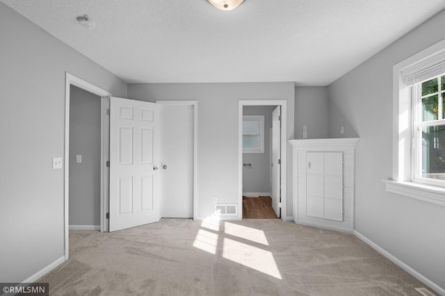 230 8th St NW, Elk River, MN 55330 - unfurnished bedroom featuring carpet floors, baseboards, and a textured ceiling