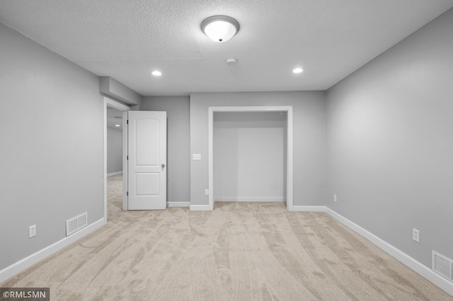230 8th St NW, Elk River, MN 55330 - unfurnished bedroom with a textured ceiling, carpet, baseboards, and recessed lighting