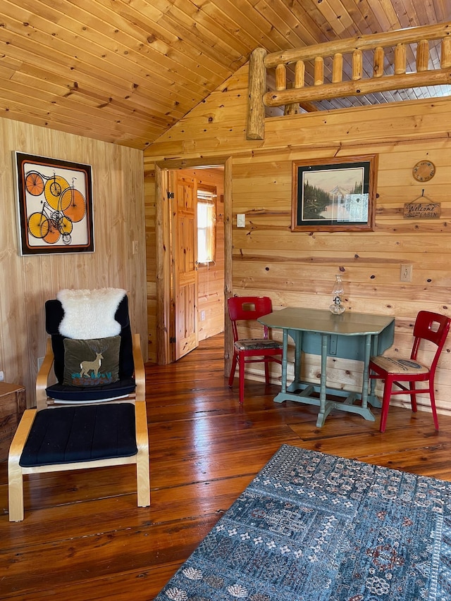 sitting room with wooden walls, wood ceiling, lofted ceiling, and hardwood / wood-style flooring