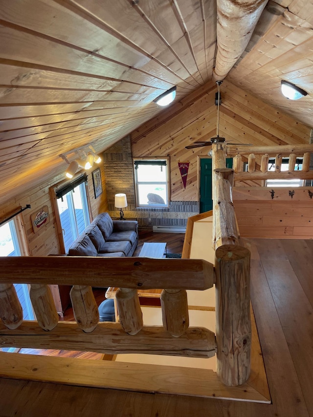 living area with wooden ceiling, vaulted ceiling, wooden walls, and hardwood / wood-style floors