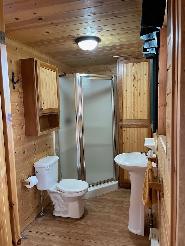 bathroom featuring wooden ceiling, wood finished floors, a shower stall, and toilet