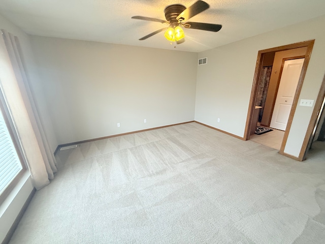 5173 Farnham Dr N, Hugo, MN 55038 - unfurnished bedroom with light colored carpet, baseboards, and ceiling fan
