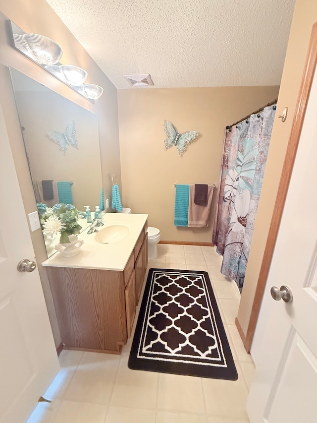 5173 Farnham Dr N, Hugo, MN 55038 - full bath featuring a textured ceiling, tile patterned flooring, vanity, toilet, and a shower with shower curtain
