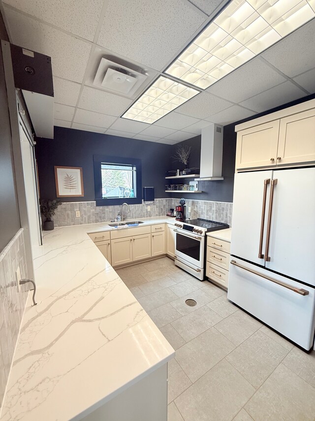 5173 Farnham Dr N, Hugo, MN 55038 - kitchen with white appliances, a sink, a drop ceiling, light stone countertops, and wall chimney range hood