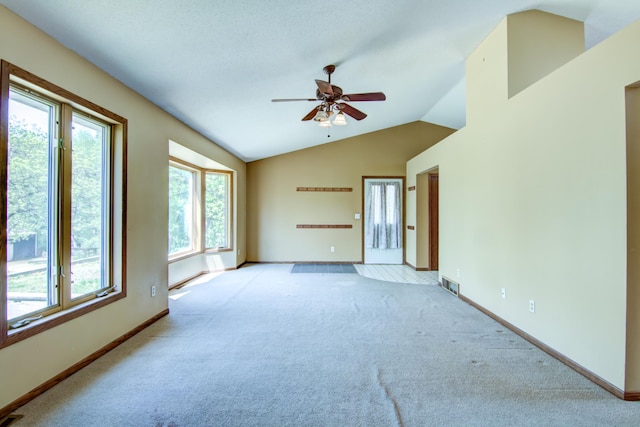 1286 Krattley Ln, North Hudson, WI 54016 - unfurnished living room featuring healthy amount of natural light, a ceiling fan, lofted ceiling, light colored carpet, and baseboards