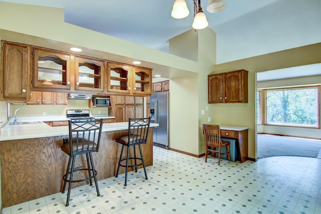 1286 Krattley Ln, North Hudson, WI 54016 - kitchen featuring appliances with stainless steel finishes, a sink, a peninsula, glass insert cabinets, and light countertops