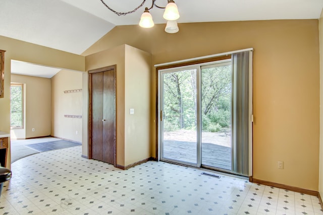 1286 Krattley Ln, North Hudson, WI 54016 - doorway to outside featuring vaulted ceiling, a chandelier, baseboards, and light flooring