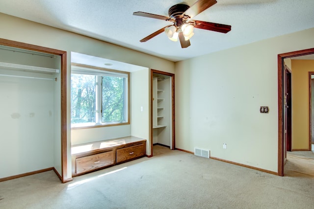 1286 Krattley Ln, North Hudson, WI 54016 - unfurnished bedroom with carpet flooring, baseboards, multiple closets, and ceiling fan