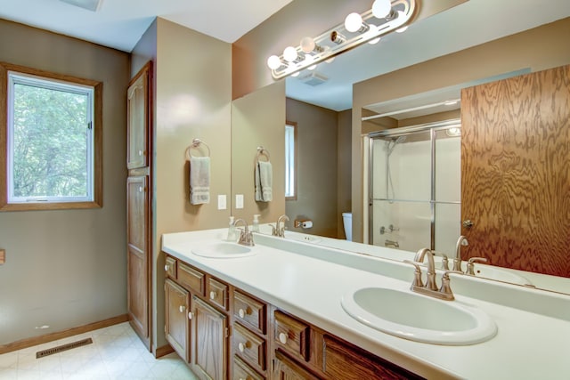 1286 Krattley Ln, North Hudson, WI 54016 - bathroom with baseboards, an enclosed shower, toilet, and double vanity
