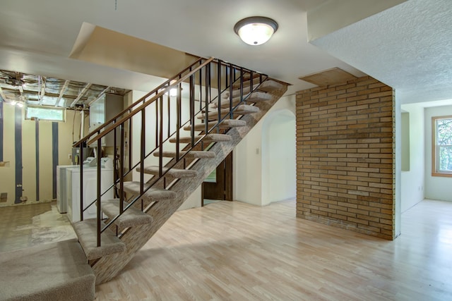 1286 Krattley Ln, North Hudson, WI 54016 - staircase with separate washer and dryer, wood finished floors, and arched walkways