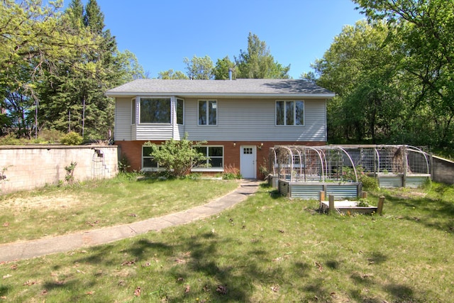 1286 Krattley Ln, North Hudson, WI 54016 - view of front of house with a garden, a front lawn, and brick siding