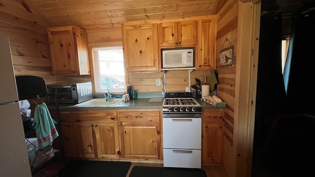 kitchen with white appliances, a sink, wooden walls, wood ceiling, and vaulted ceiling