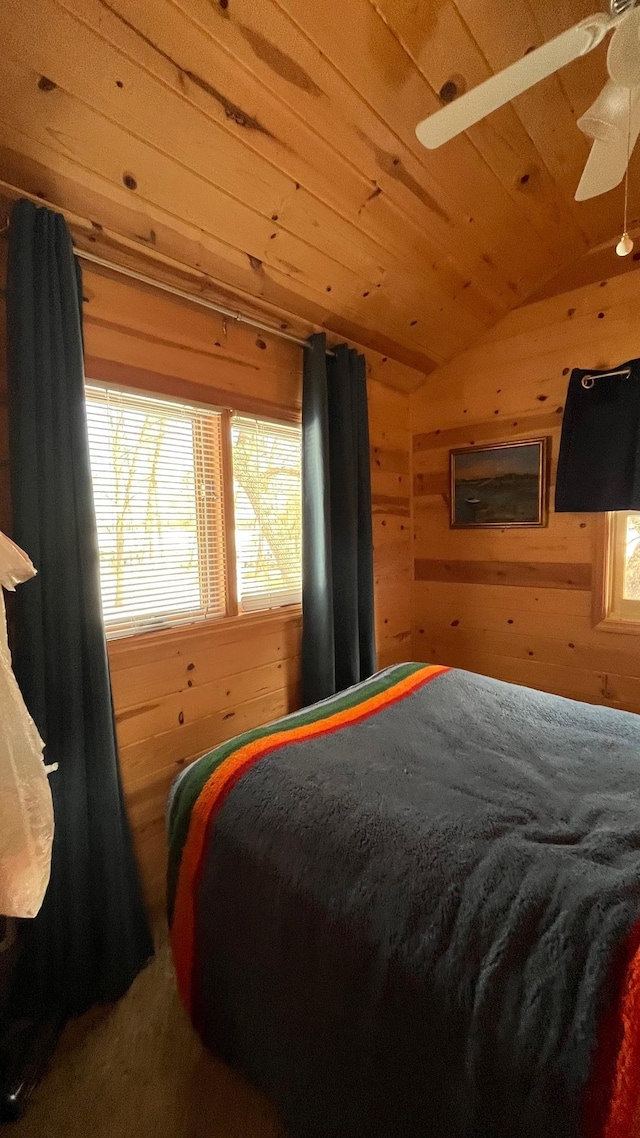 bedroom featuring lofted ceiling, wooden walls, and wood ceiling