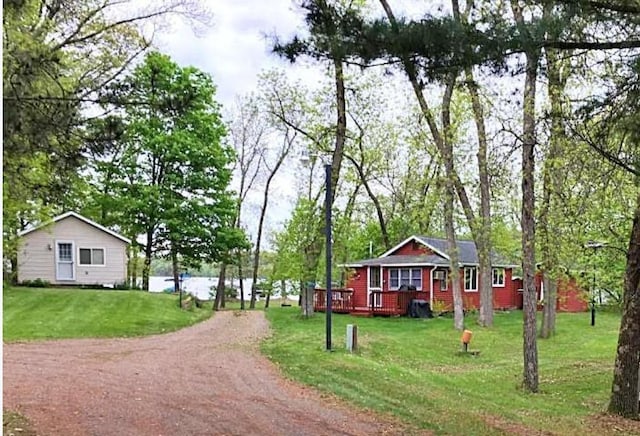 surrounding community with driveway and a lawn