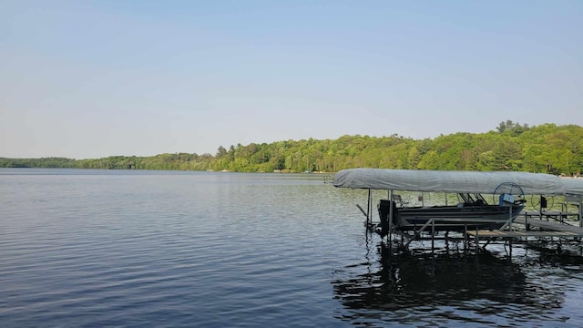 16056 Eagle Lake Ln, Brainerd, MN 56401 - dock area featuring boat lift, a water view, and a wooded view
