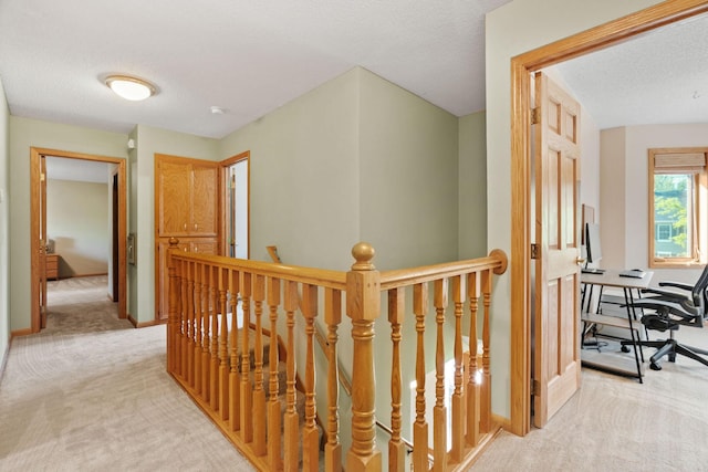 11600 43rd Ave N, Plymouth, MN 55442 - hall with an upstairs landing, light colored carpet, a textured ceiling, baseboards, and an office area