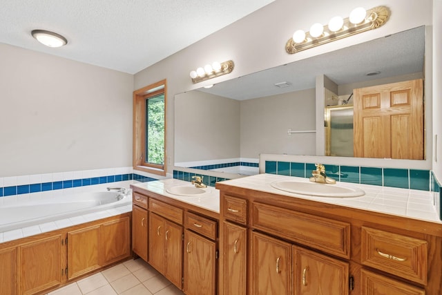 11600 43rd Ave N, Plymouth, MN 55442 - full bathroom with double vanity, a shower stall, a garden tub, tile patterned flooring, and a textured ceiling