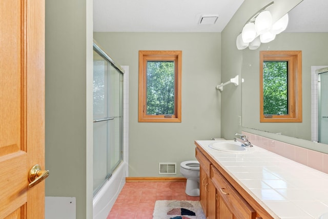 11600 43rd Ave N, Plymouth, MN 55442 - full bath with toilet, plenty of natural light, vanity, and tile patterned flooring