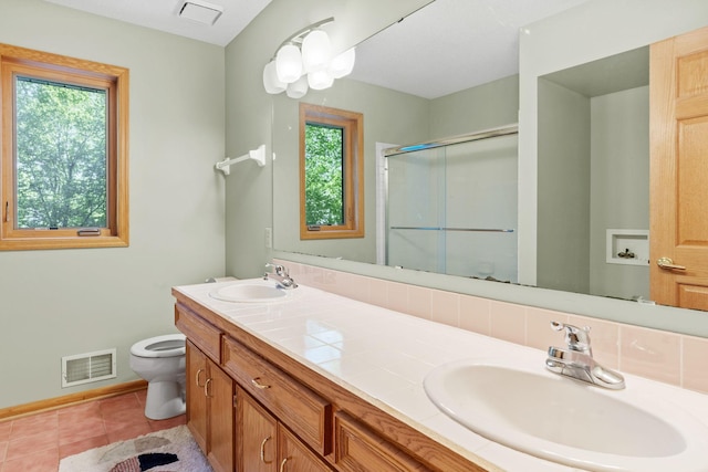 11600 43rd Ave N, Plymouth, MN 55442 - bathroom featuring toilet, a stall shower, double vanity, tile patterned flooring, and baseboards