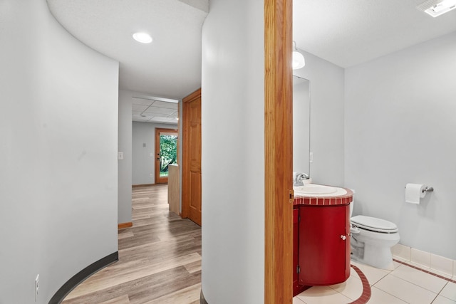 11600 43rd Ave N, Plymouth, MN 55442 - bathroom with vanity, baseboards, toilet, wood finished floors, and a drop ceiling