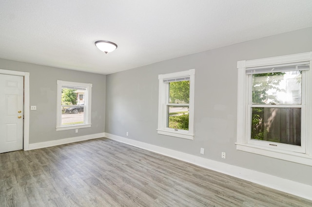 476 Brainerd Ave, Saint Paul, MN 55130 - spare room featuring wood finished floors, plenty of natural light, and baseboards