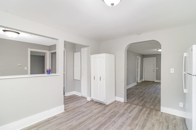 476 Brainerd Ave, Saint Paul, MN 55130 - spare room with arched walkways, light wood finished floors, and baseboards