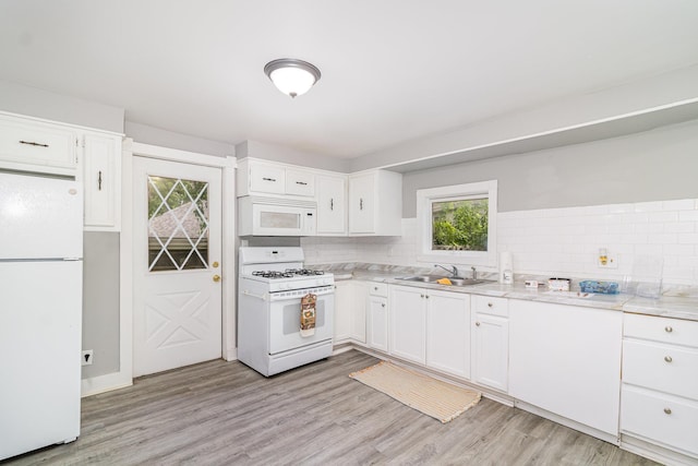 476 Brainerd Ave, Saint Paul, MN 55130 - kitchen with white appliances, a sink, tasteful backsplash, light wood-style flooring, and white cabinets