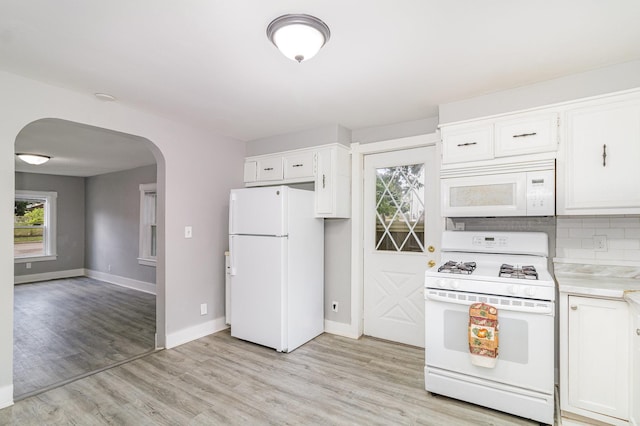 476 Brainerd Ave, Saint Paul, MN 55130 - kitchen with white appliances, arched walkways, baseboards, and light countertops