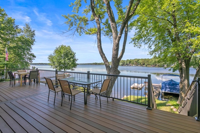 12177 Fremont Ln, Zimmerman, MN 55398 - wooden terrace featuring outdoor dining space and a water view