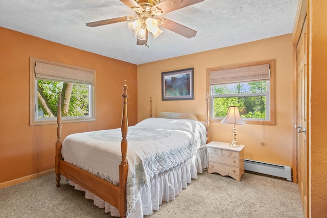 12177 Fremont Ln, Zimmerman, MN 55398 - bedroom featuring a baseboard heating unit, carpet floors, a textured ceiling, and ceiling fan