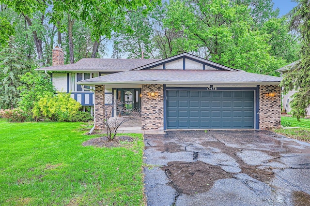 11476 65th Pl N, Maple Grove, MN 55369 - view of front of home with asphalt driveway, a chimney, a front lawn, an attached garage, and brick siding