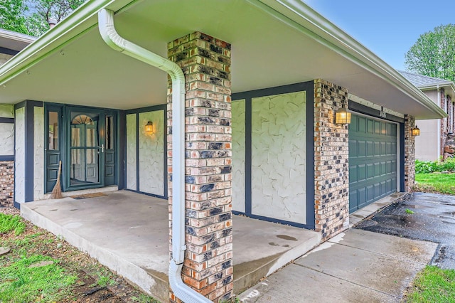 11476 65th Pl N, Maple Grove, MN 55369 - entrance to property featuring brick siding, asphalt driveway, and a garage