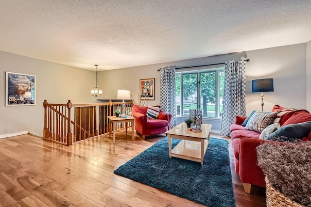 11476 65th Pl N, Maple Grove, MN 55369 - living room with a chandelier, hardwood / wood-style floors, a textured ceiling, and baseboards