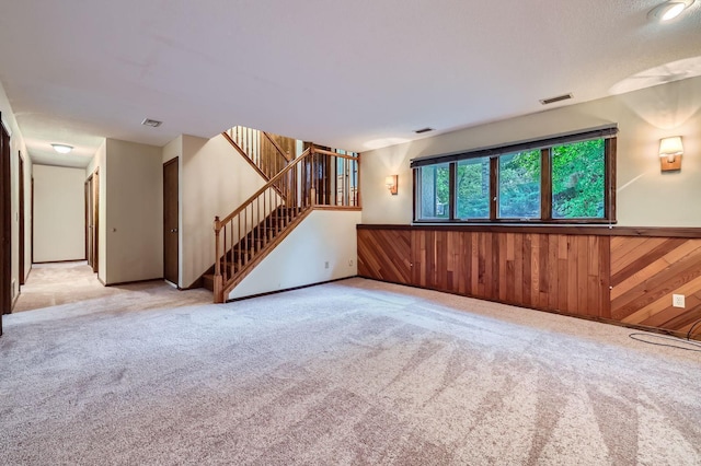 11476 65th Pl N, Maple Grove, MN 55369 - empty room with stairs, wainscoting, light carpet, and wood walls