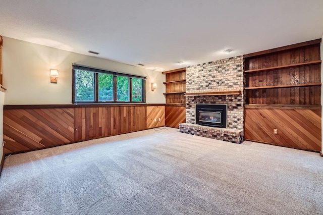 11476 65th Pl N, Maple Grove, MN 55369 - unfurnished living room featuring wood walls, wainscoting, carpet, a fireplace, and built in features